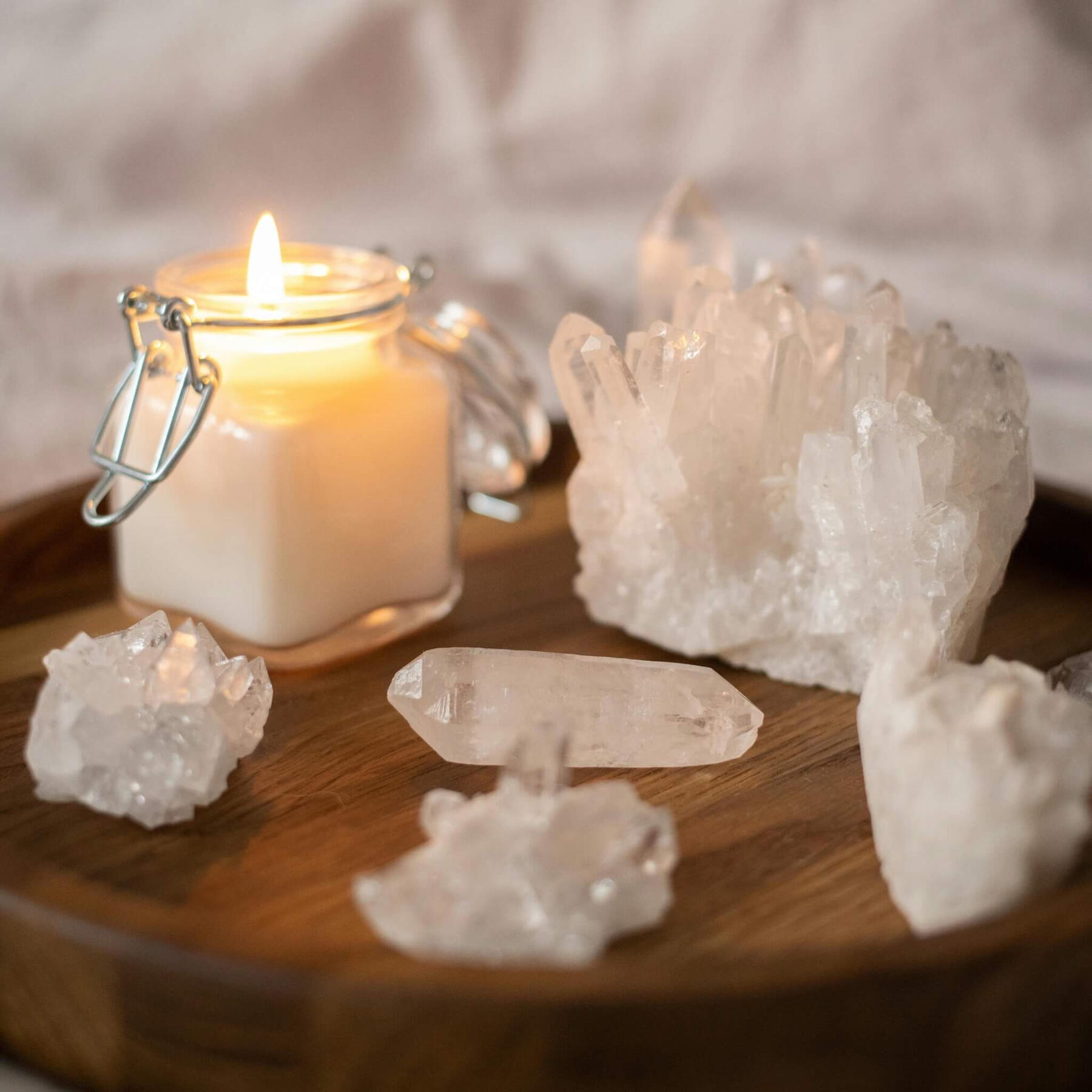 This is a photo of some clear quartz crystals and a white candle.